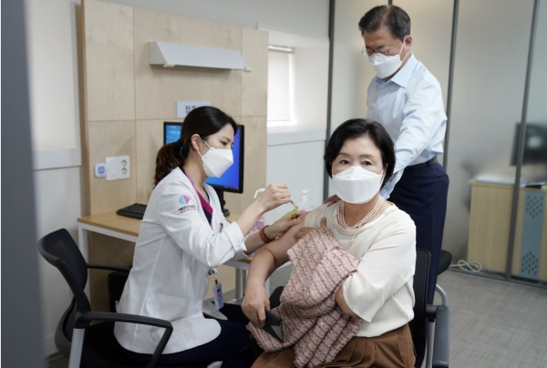 김정숙 여사가 15일 문재인 대통령과 서울 국립중앙의료원 코로나19 중앙예방접종센터에서 코로나19 백신 추가 접종을 받고 있다.