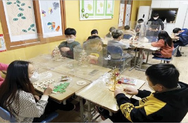풀잎지역 아동센터 내 학습실에서 아동들이 만들기 수업에 참여하고 있다.